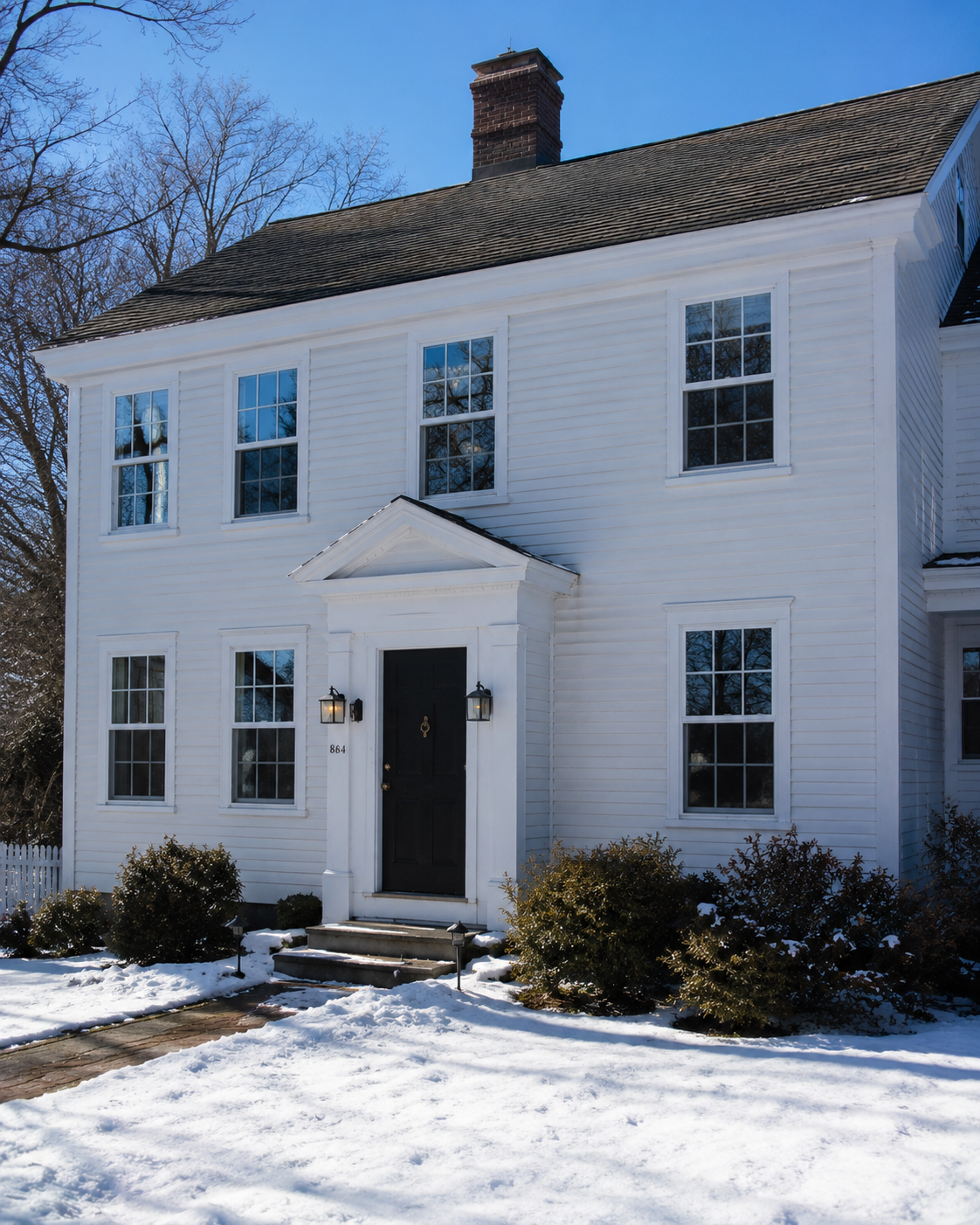 A Connecticut home window upgrade in progress, ENERGY STAR Northern-Zone windows being set into the rough opening of a Fairfield County Cape